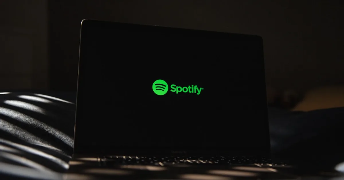 a laptop computer sitting on top of a bed