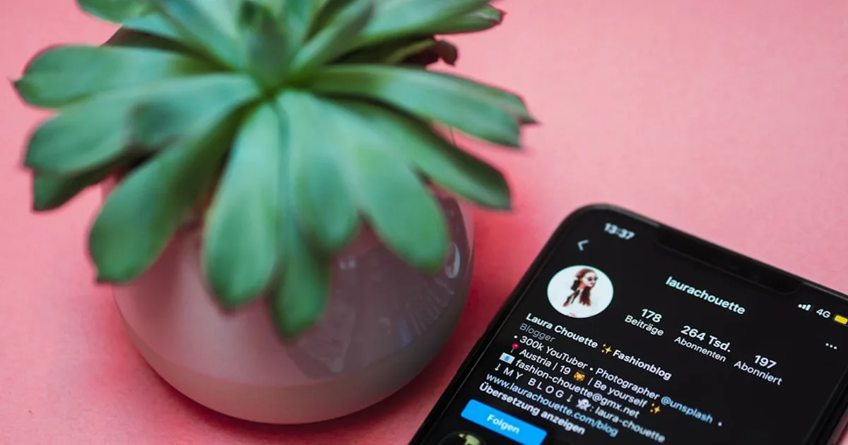 black iphone 4 on pink surface