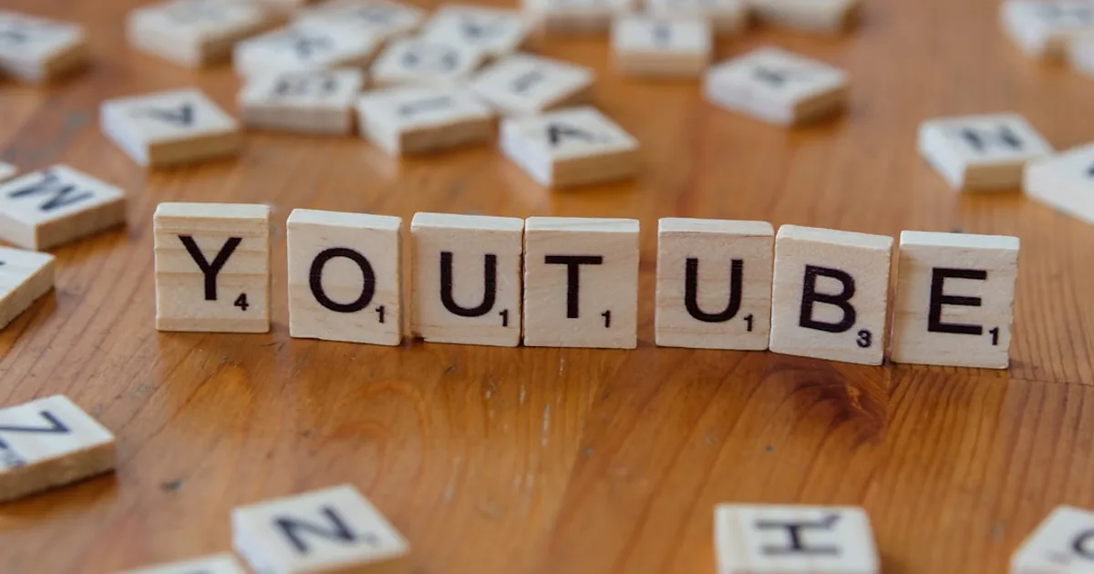A wooden block spelling out the word youtube on a table